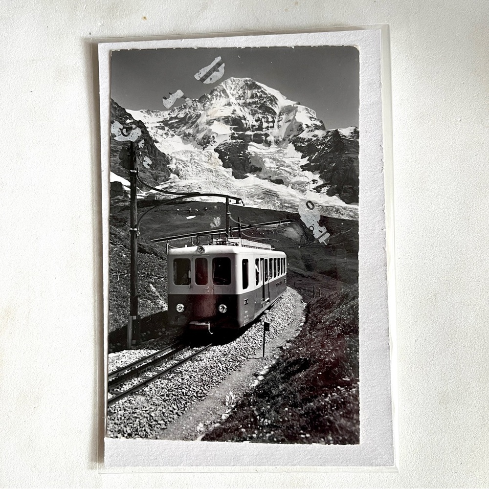 Vintage postcard of snow mountains. The alps? Unique. With an old cable car.